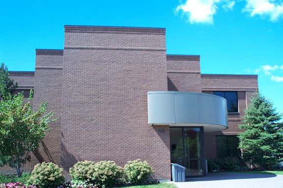 A building with a brick facade and a large glass entrance.