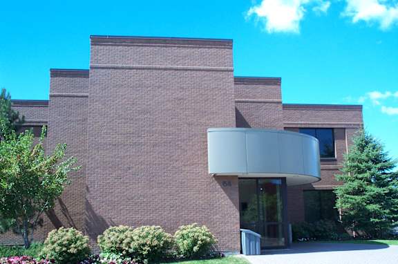 A building with a brick facade and a large glass entrance.