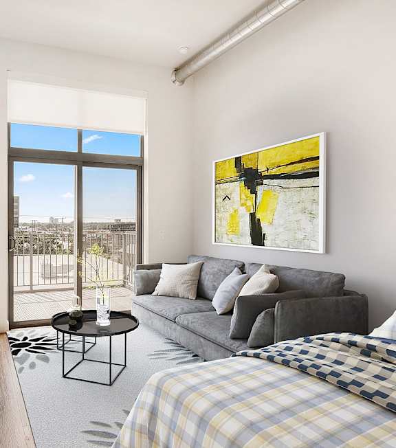 A well-lit bedroom with a large bed and a painting on the wall. at RiDE at RiNo Apartments, Colorado
