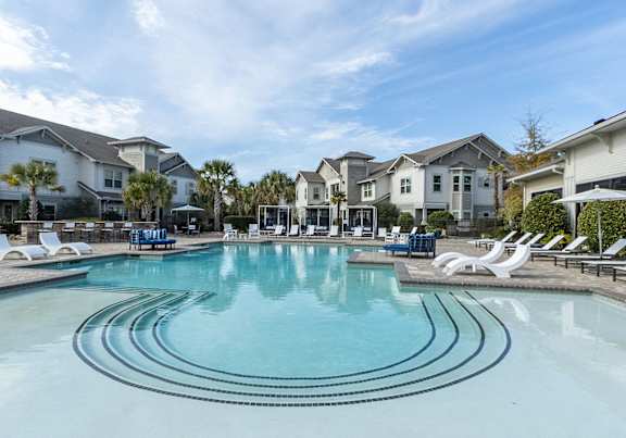 A large swimming pool in front of a resort.