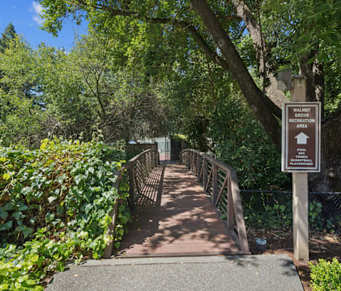 A bridge with a sign that says Walkway Recreation.