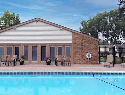 a brick building with a pool in front of it