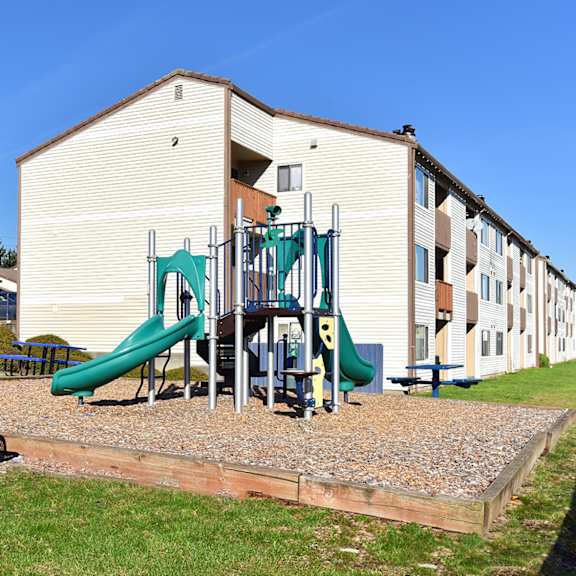 a playground in front of an apartment building