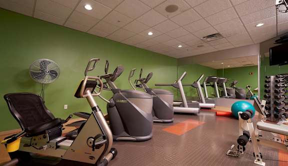 a gym with various exercise bikes and weights