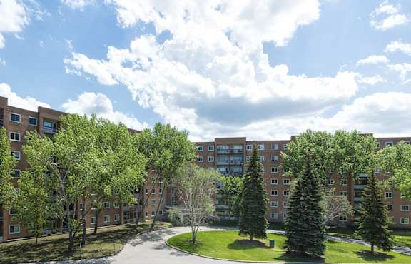 A large building with a green lawn in front of it.