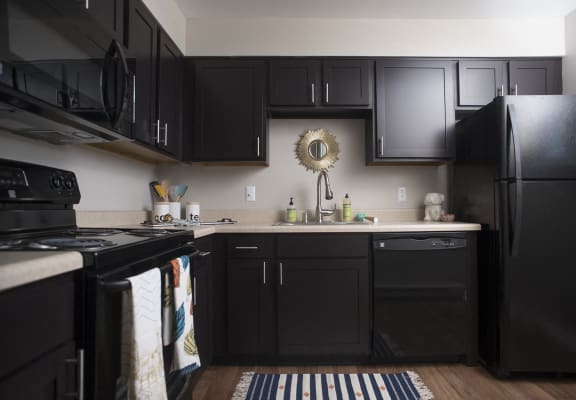 Modern kitchen with black appliances at Crescent Centre Apartments, Kentucky, 40202