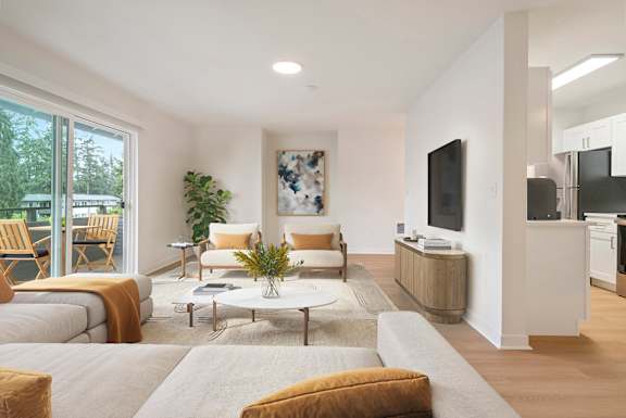 A living room with a couch, chairs, and a coffee table.