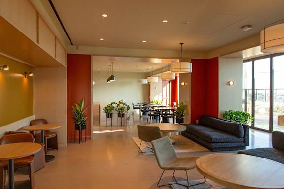 A modern office space with a variety of seating options and plants. at Scout Living, powered by Placemakr Apartments, Atlanta, GA, 30308