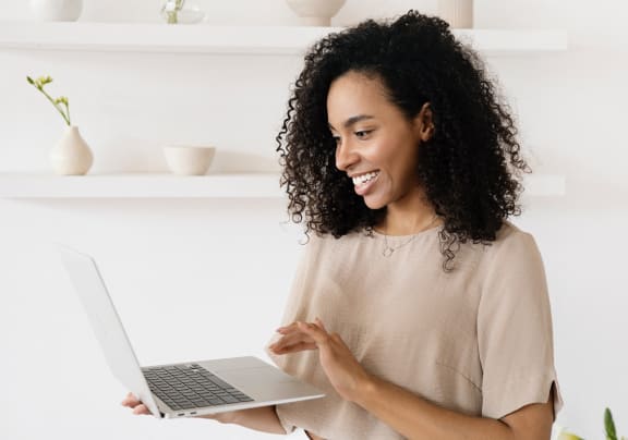 a woman using a laptop computer in her kitchen
