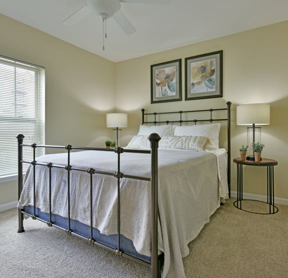 a bedroom with a bed and a ceiling fan at Badger Canyon Apartments in Kennewick, WA 99338