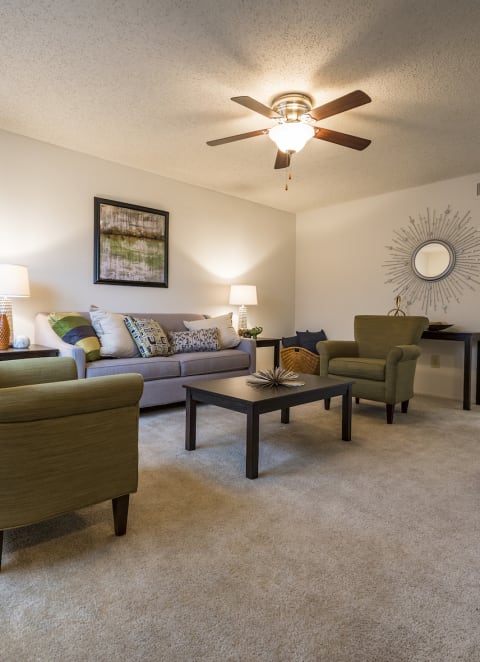 a living room with couches and chairs and a ceiling fan at MeadowView Townhomes, Ohio, 45122