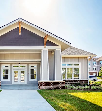 A modern building with a front porch and a covered entrance.