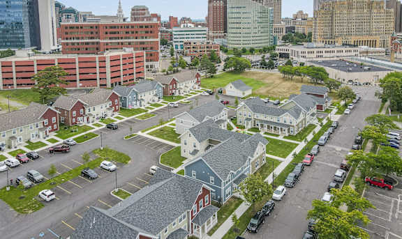 an aerial view of a neighborhood with a large city in the background at Niagara Square Apartments, Buffalo, NY 14201