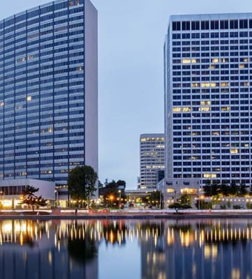a city skyline with a lake in the foreground