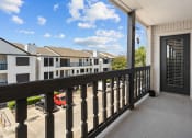 Thumbnail 10 of 29 - the view from the balcony of a home with a black railing and a door