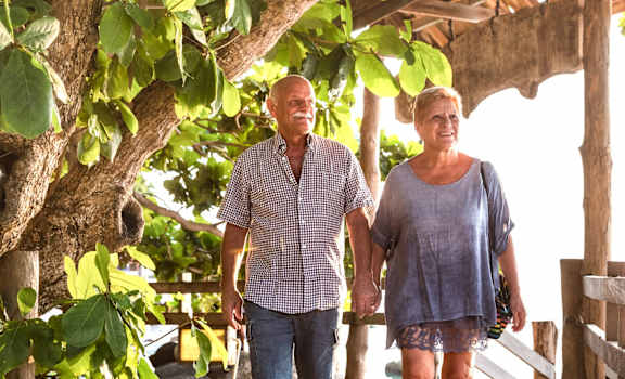 a man and a woman walking on a wooden bridge at Grandeville on Saxon, Orange City, 32763