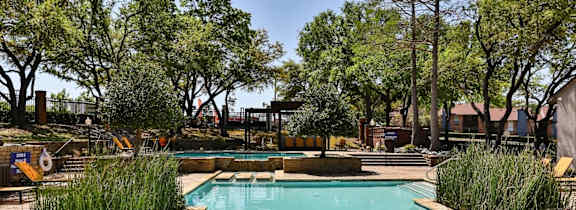 A large house with a pool in front.