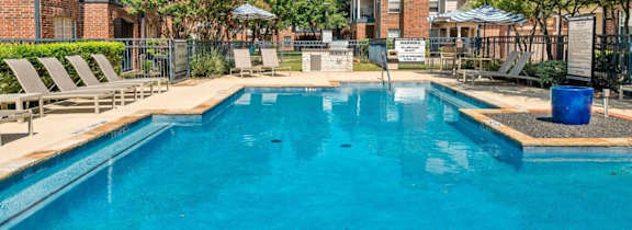 A large house with a pool in front.