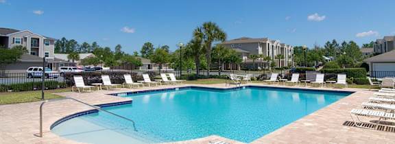 A large house with a pool in front.