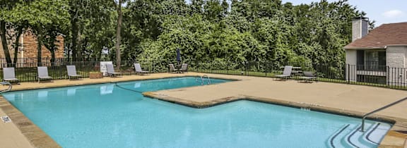 A large house with a pool in front.