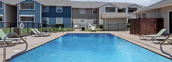 A large house with a pool in front.