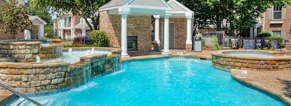 A large house with a pool in front.