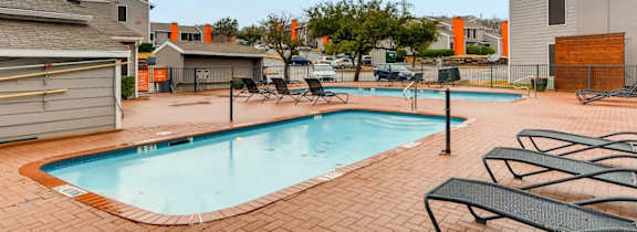 A large house with a pool in front.