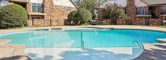 A large house with a pool in front.