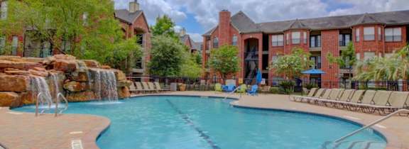 A large house with a pool in front.