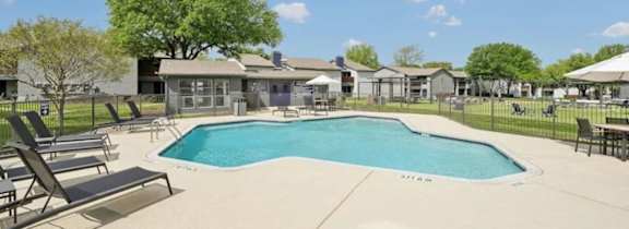 A large house with a pool in front.