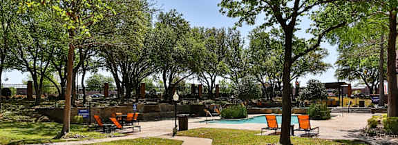 A large house with a pool in front.