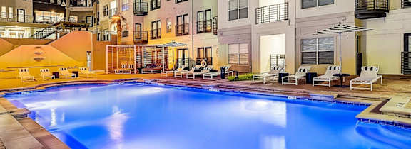 A large house with a pool in front.