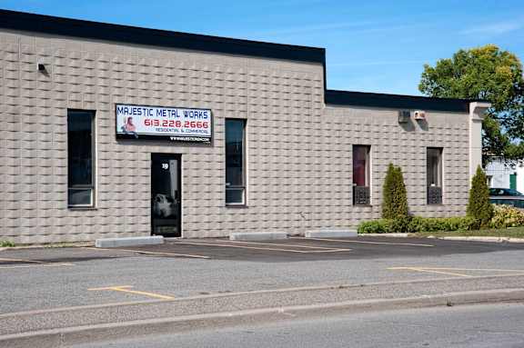A building with a sign that says "Marist Metal Works" and a phone number.