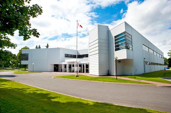A white building with a Canadian flag on top.