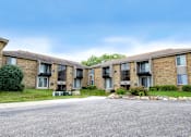 Thumbnail 2 of 32 - Apartment complex with a grey road in front.