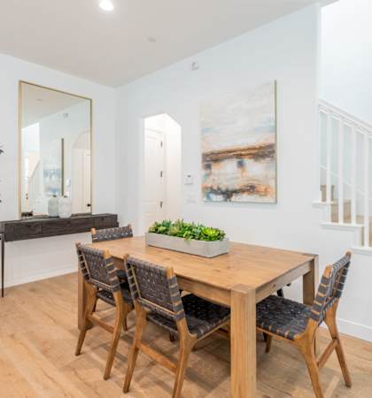 A dining room with a wooden table and chairs.at Crocker Village – Single Family Homes, Sacramento California