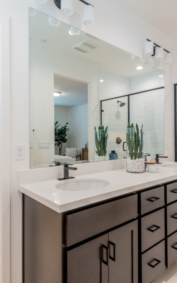 A bathroom with a white sink and a white toilet.at Crocker Village – Single Family Homes, Sacramento California