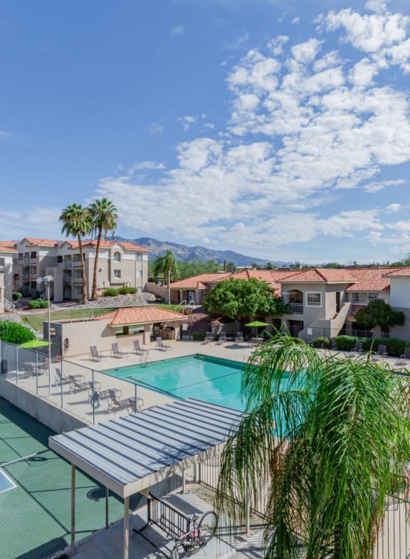 a swimming pool with a tennis court and buildings in the background at Promontory, Arizona, 85704