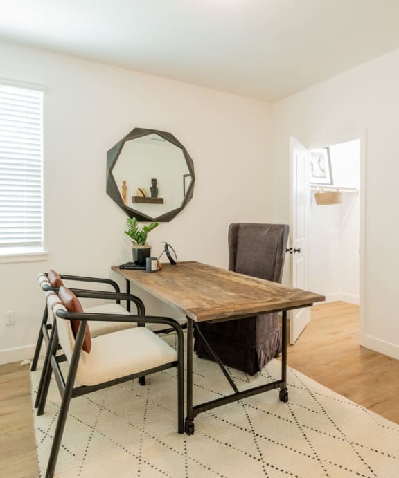 A dining room with a wooden table and chairs.at Crocker Village – Single Family Homes, Sacramento, 95818