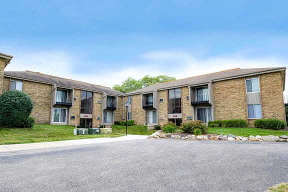 Apartment complex with a grey road in front.