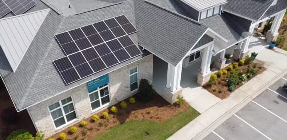 an aerial view of a house with solar panels on the roof