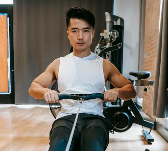 a man riding an exercise bike in a gym