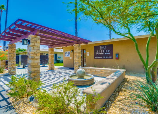 Apartments in Colton, CA - Exterior View of Las Brisas Leasing Office, Surrounded by Lush Landscaping and Walkways at Las Brisas Apartments, California