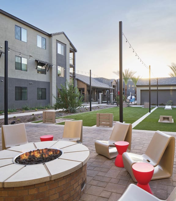 an outdoor patio with chairs and a fire pit
