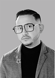 a man wearing glasses and a black shirt and a gray jacket