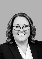 a black and white photo of a woman wearing glasses