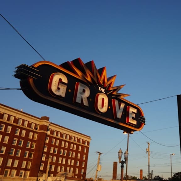 A large sign with the word "GROVE" on it is in the foreground.