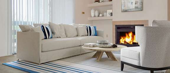 a living room with a couch and a chair and a fireplace