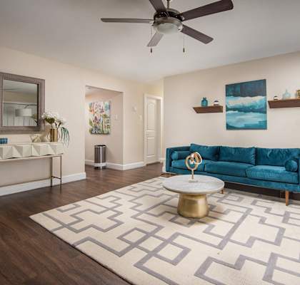 a living room with a blue couch and a white rug at Aspen Grove Apartment Homes, Pennsylvania