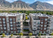 Thumbnail 2 of 4 - Aerial view of an apartment building with mountains in the background at 200 City View, Provo